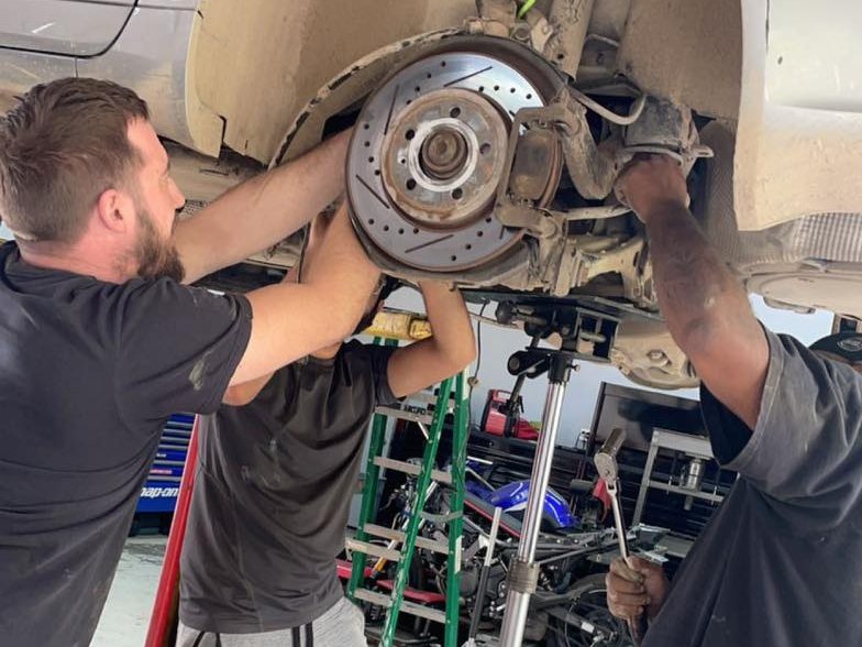 Mechanics working on brakes